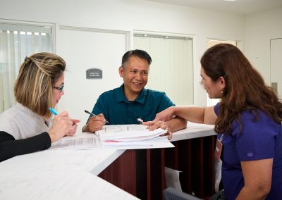 Two caregivers at the nurse's station in the Valle Vista facility