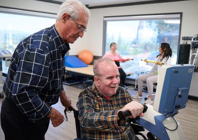 A therapist with a resident in the rehab gym of the Valle Vista facility