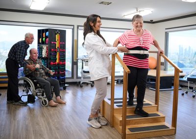 A therapist with a resident in the rehab gym of the Valle Vista facility