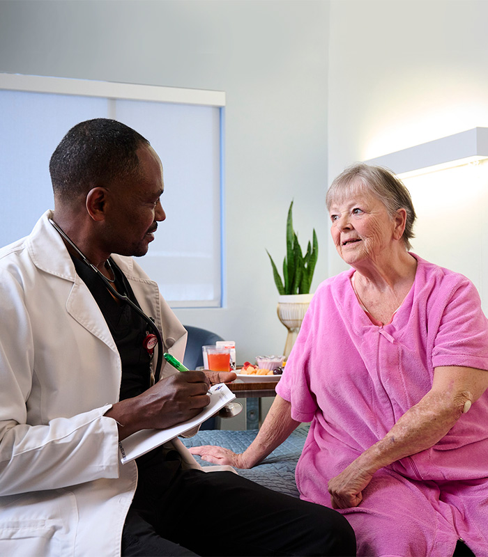 An  caregiver with a resident in the Valle Vista facility