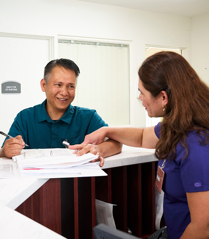 Two caregivers at the nurse's station in the Valle Vista facility